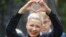 FILE – Belarus opposition activist Maria Kolesnikova gestures on the way to the Belarusian Investigative Committee in Minsk, Belarus, on Aug. 27, 2020. 