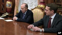 FILE - Russian Federal Security Service head Alexander Bortnikov, left, and Foreign Intelligence Service chief Sergei Naryshkin are seen during a meeting in the Kremlin, in Moscow, Russia, Dec. 19, 2016. 