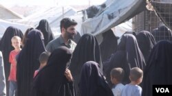 Foreign women in al-Hol camp crowd around VOA journalists, complaining their sons were taken to a deradicalization center on Oct. 20, 2021 in al-Hol, Syria. (Ali Zeyno/VOA)
