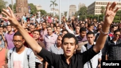 Cairo university students and members of the Muslim Brotherhood shout slogans against the military, in front of Cairo University in Cairo, Oct. 8, 2013.