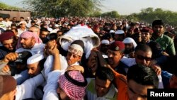 FILE - Mourners carry the body of one of the three policemen who were killed, March 3, 2015, by a remotely detonated bomb in the village of Daih.