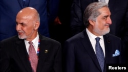 FILE - Afghanistan's President Ashraf Ghani (L) and Afghanistan's Chief Executive Abdullah Abdullah (R) attend the NATO Summit in Warsaw, Poland July 8, 2016.