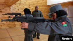 Afghan policewomen aim their guns during shooting exercises at the Afghan National Police Academy shooting range, in Kabul December 9, 2012.