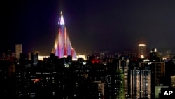 The Ryugyong Hotel is illuminated in the night sky in Pyongyang, North Korea, Sept. 6, 2018, days before the 70th anniversary of the founding of North Korea. 