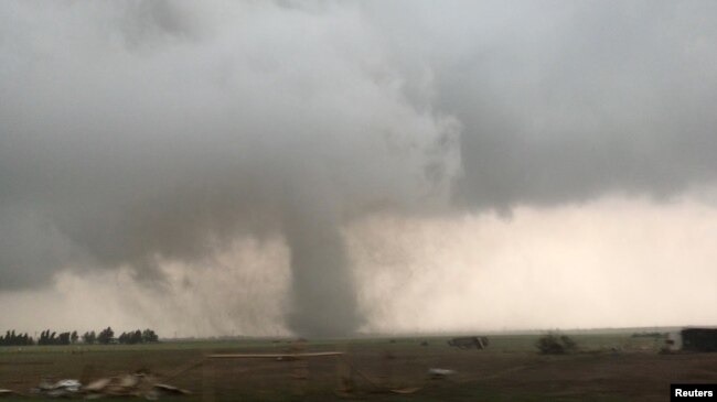 FILE - A tornado spins during stormy weather in Mangum, Okla., May 20, 2019 in this still image taken from a video from social media. (Lorraine Matti via REUTERS)