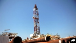 Drilling tubing is piled next to the drilling site number 102 in the Unity oil field in Southern Sudan ( November 2010 file photo)