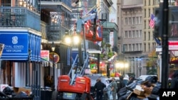 Police investigators surround a white truck that has been crashed into a work lift in the French Quarter of New Orleans, Louisiana, Jan. 1, 2025.