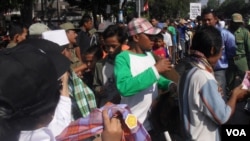 Para tukang becak dan warga miskin di Solo menerima pembagian sarung dan uang untuk lebaran (foto: Yudha/VOA).