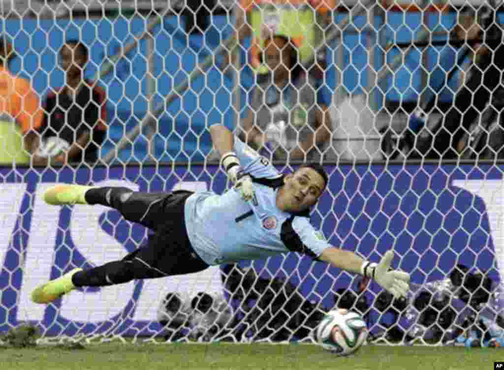 Costa Rica's goalkeeper Keylor Navas dives trying to save a penalty kick during penalty kicks at the World Cup quarterfinal soccer match between the Netherlands and Costa Rica at the Arena Fonte Nova in Salvador, Brazil, Saturday, July 5, 2014. The Nether