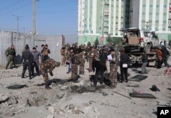 Afghan security personnel investigate at the site of a bomb attack in Kabul, Dec. 15, 2020. A bombing and a shooting attack in the capital killed several people, including Kabul's deputy governor.