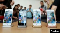 FILE - The iPhone SE is seen on display during an event at the Apple headquarters in Cupertino, California, March 21, 2016. 