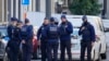 FILE — Belgian Police patrol behind a cordoned off area close to where a suspected Tunisian extremist has been shot dead hours after manhunt looking for him, Oct. 17, 2023. 