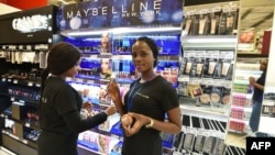 Sales assistants work at a Carrefour supermarket in Abidjan on Dec. 18, 2015 on opening day. 