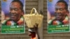 FILE - A street vendor carries fruit outside an election rally of President Emmerson Mnangagwa's ruling ZANU-PF party in Mutare, Zimbabwe, May 19, 2018. 