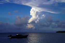 FILE: White gaseous clouds rise from the Hunga Ha'apai eruption seen from the Patangata coastline near Tongan capital Nuku'alofa, Dec. 21, 2021.