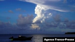 FILE: White gaseous clouds rise from the Hunga Ha'apai eruption seen from the Patangata coastline near Tongan capital Nuku'alofa, Dec. 21, 2021.