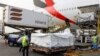 Workers offload boxes of AstraZeneca/Oxford vaccines as the country receives its first batch of coronavirus disease (COVID-19) vaccines under COVAX scheme, at the international airtport of Accra, Ghana