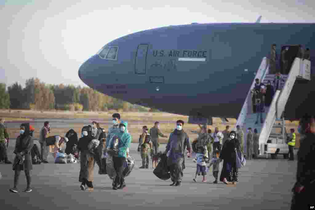 Evacuees from Afghanistan disembark from a U.S. airforce plane at the Naval Station in Rota, southern Spain.&nbsp;The United States completed its withdrawal from Afghanistan, ending America&#39;s longest war.