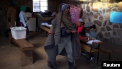 FILE - Locals arrive to cast their vote during the national elections at Semonkong, Lesotho, June 3, 2017. 