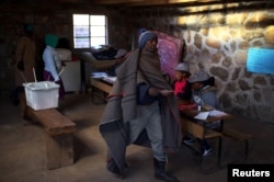 FILE - Locals arrive to cast their vote during the national elections at Semonkong, Lesotho, June 3, 2017.