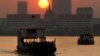 FILE - Ferries transport villagers, students and civil servants from Phnom Penh to Arey Ksat across the Mekong River as the sun sets in Phnom Penh, Cambodia, Saturday, Jan. 31, 2015. (AP Photo/Heng Sinith)