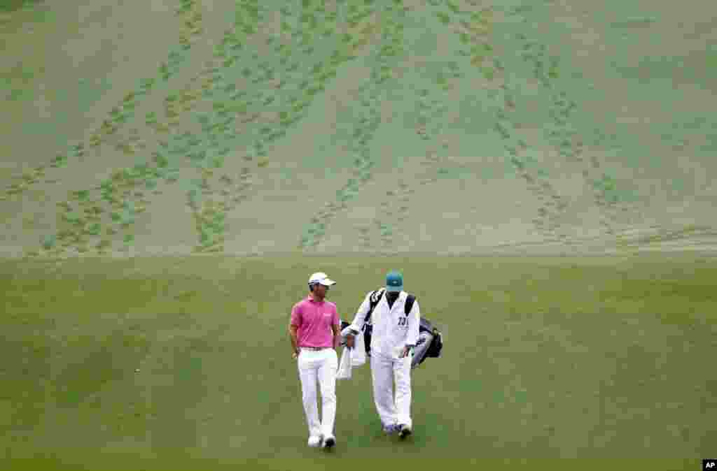 Mike Weir of Canada walks with his caddie down the first fairway during a practice round for the Masters golf tournament in Augusta, Georgia, USA.