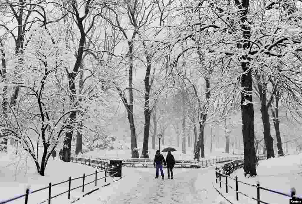 A couple walks hand in hand through the snow at Central Park in New York. A slow moving winter storm brought a combination of snow, rain and high winds to the northeast U.S. after moving through the mid-Atlantic states earlier in the week. 