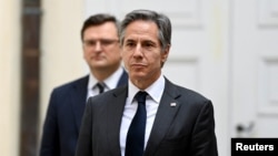 US Secretary of State Antony Blinken stands close to Ukrainian Foreign Minister Dmytro Kuleba as they meet with the Foreign Ministers of the G7 Nations on the sidelines of the Munich Security Conference (MSC) in Munich, Germany, February 19, 2022.