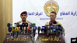 U.S. Army Colonel Ryan Dillon, Spokesman for Operation Inherent Resolve (OIR), the U.S.-led coalition against the Islamic State grou, right, speaks during a joint press conference with Gen. Yahya Rasool, an Iraqi military spokesman in the Ministry of Defense in Baghdad, Iraq, Aug. 24, 2017.