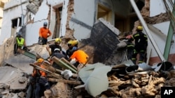 Chilean and Lebanese rescuers search in the rubble of a building that collapsed in last month's massive explosion, after getting signals there may be a survivor under the rubble, in Beirut, Lebanon, Sept. 3, 2020.