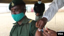 A prison official being vaccinated at Chikurubi Maximum Prison in Harare in October 2021 (VOA/Columbus Mavhunga)
