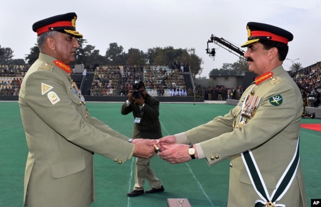 FILE - In this photo released by Inter Services Public Relations, the public relations arm of Pakistan's army, Pakistan's outgoing Army Chief Gen. Raheel Sharif, right, hands over a ceremonial baton to his successor Gen. Qamar Javed Bajwa during the Change of Command ceremony in Rawalpindi, Pakistan, Nov. 29, 2016.