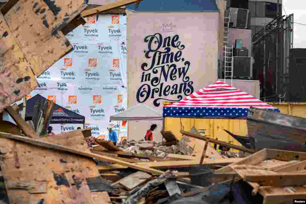 Workers clean up the site of the Historic Karnofsky Shop, which collapsed during Hurricane Ida, in New Orleans, Louisiana, Sept. 6, 2021.