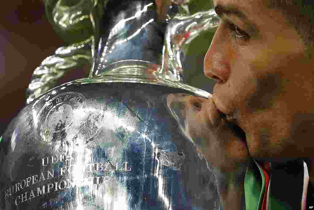 Le portugais Cristiano Ronaldo embrasse le trophée de l'Euro 2016 après le sacre du Portugal, 10 juillet 2016. 