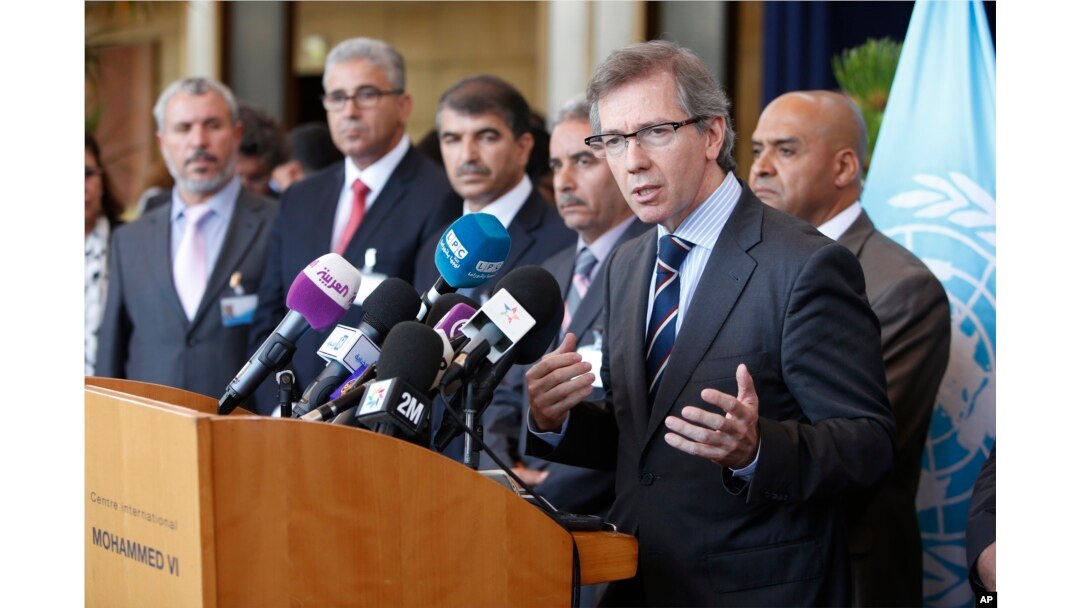 U.N. representative for Libya, Bernardino Leon, right, addresses reporters while Libyan parliaments members listen in Rabat, Morocco, Sept. 18, 2015.