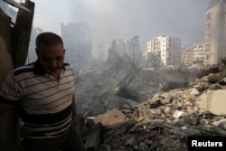 A man stands near damaged buildings in the aftermath of Israeli air strikes on Beirut's southern suburbs in Lebanon on Sept. 28, 2024.