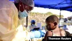 FILE - A Congolese health worker administers Ebola vaccine to a child at the Himbi Health Centre in Goma, Democratic Republic of Congo, July 17, 2019. 