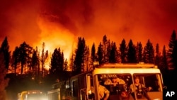 Firefighters arrive at Frenchman Lake to battle the Sugar Fire, part of the Beckwourth Complex Fire, burning in Plumas National Forest, Calif., on July 8, 2021.