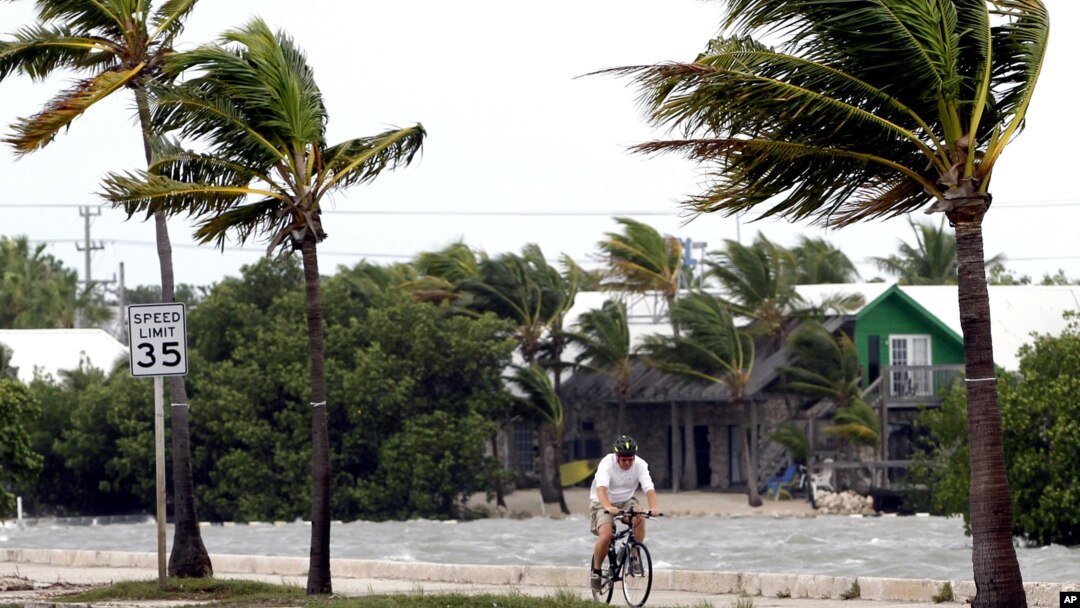 A cyclist rides his bike in Key West, Florida, Sunday, Aug. 26, 2012. Tropical Storm Isaac gained fresh muscle Sunday as it bore down on the Florida Keys, with forecasters warning it could grow into a dangerous Category 2 hurricane as it nears the norther