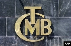 A picture taken on Aug. 14, 2018 shows the logo of Turkey's Central Bank (TCMB) at the entrance of the bank's headquarters in Ankara, Turkey