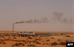 FILE - A Saudi Aramco oil installion known as "Pump 3" in the desert near the oil-rich area of Khouris, 160 km east of the Saudi capital Riyadh.