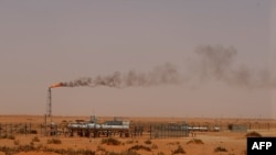 FILE - A Saudi Aramco oil installion known as "Pump 3" in the desert near the oil-rich area of Khouris, 160 km east of the Saudi capital Riyadh.