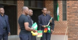 Men hand out flags to people praying for peace in Cameroon's restive English-speaking regions, at Saint Joseph's Anglophone Parish in Cameroon's capital, Yaounde, Sept. 6, 2019. (M.Kindzeka/VOA)