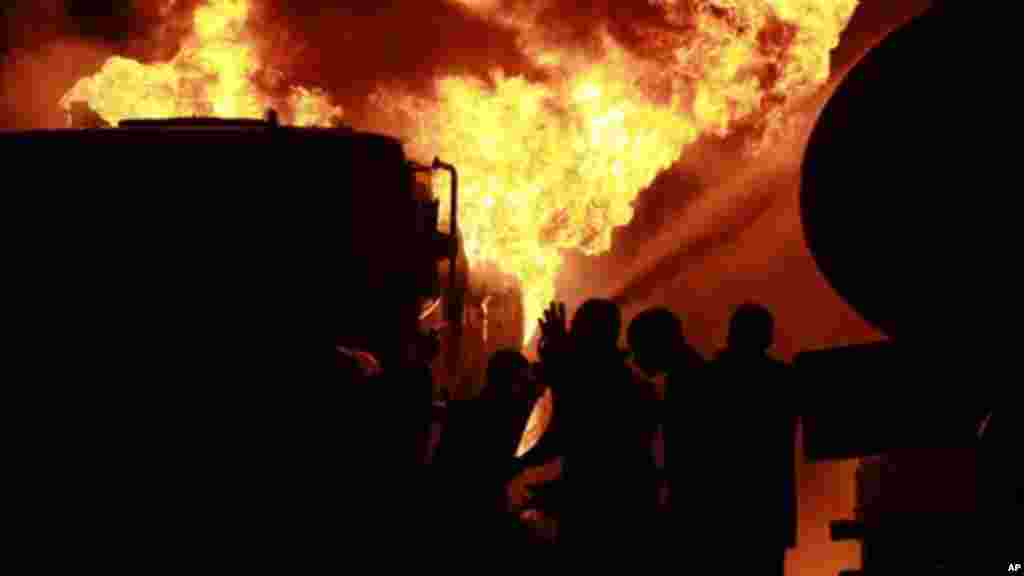 Firefighters try to contain a fire at an informal diesel fuel depot in Lagos, on Thursday, Aug. 1, 2013.
