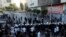 A formation of Palestinian police stands ahead of demonstrators during a protest over the death of Nizar Banat, a critic of the Palestinian Authority, in Ramallah in the Israeli-occupied West Bank, June 26, 2021. 