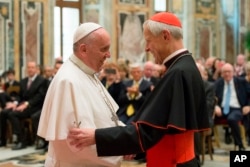 FILE - Pope Francis talks with Papal Foundation Chairman Cardinal Donald Wuerl, Archbishop of Washington, D.C., during a meeting with members of the Papal Foundation at the Vatican, April 17, 2015.