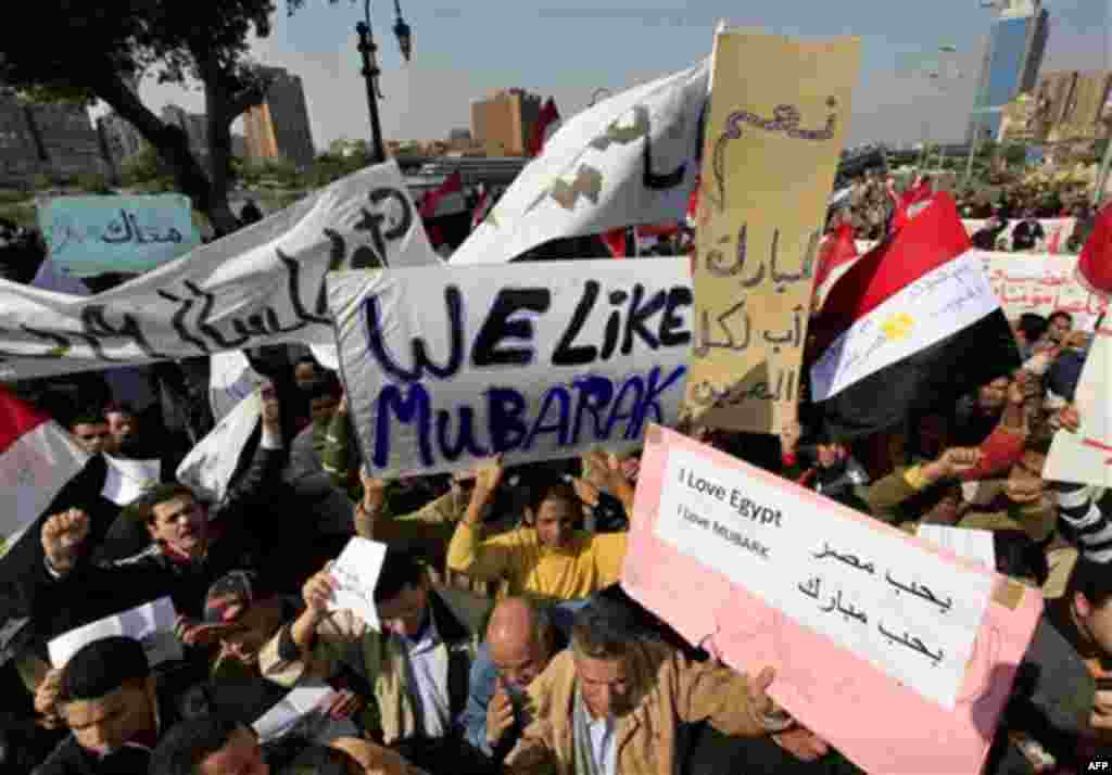 Supporters of Egyptian President Hosni Mubarak shout slogans during a march in Cairo, Egypt, Tuesday, Feb. 1, 2011. Egyptian authorities battled to save President Hosni Mubarak's regime with a series of concessions and promises to protesters, but realitie