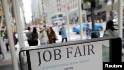 FILE - Signage for a job fair is seen on 5th Avenue in Manhattan, New York City, Sept. 3, 2021. 