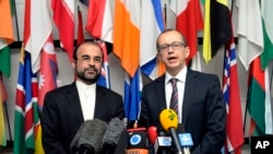 Iran's Ambassador to the IAEA, Reza Najafi (L) and IAEA Deputy Director General, Head of the Department of Safeguards, Tero Tapio Varjoranta talk to the media in Vienna, Austria, Oct. 29, 2013.