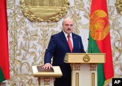 FILE - Belarusian President Alexander Lukashenko takes his oath of office during his inauguration ceremony at the Palace of the Independence in Minsk, Belarus, Sept. 23, 2020.